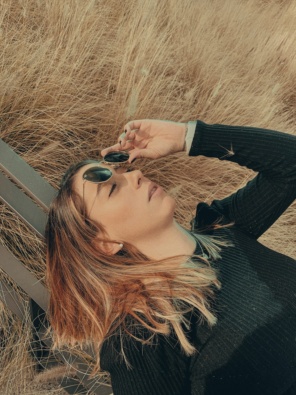 woman in black long sleeve shirt wearing black sunglasses