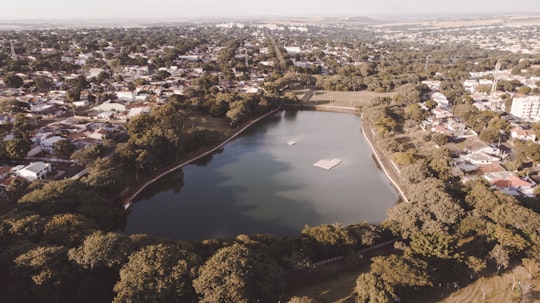 aerial view of city buildings and river during daytime in Maringá Brasil