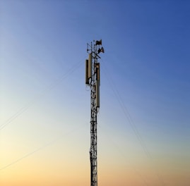 black electric post under blue sky during daytime