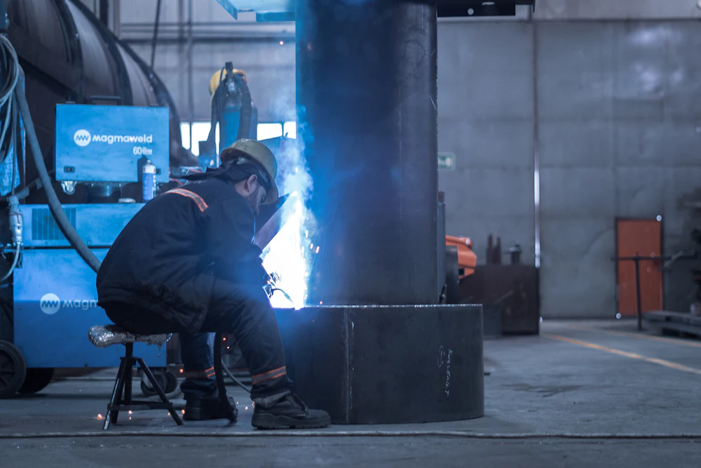 Worker in branded workwear and helmet