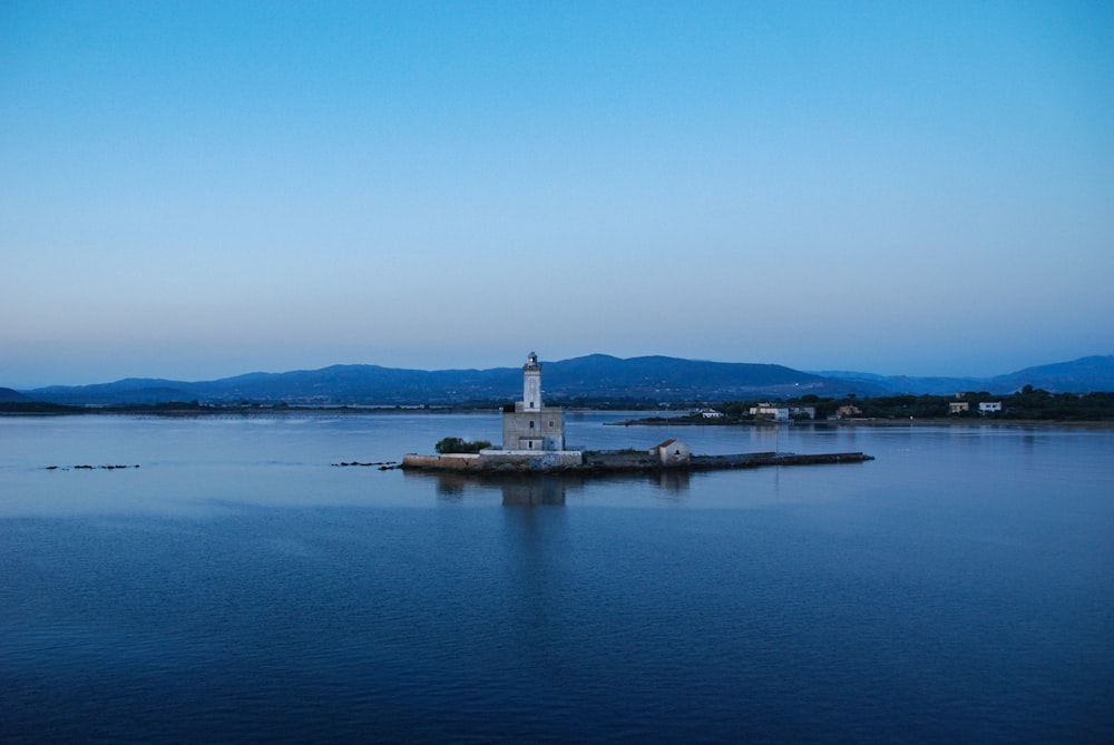 white concrete building on body of water during daytime