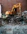 yellow excavator beside brown brick wall