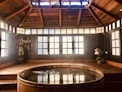 brown wooden round table near glass window