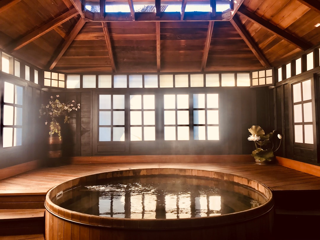 brown wooden round table near glass window, Hot Spring in Winter