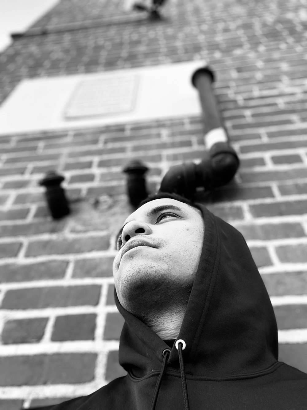 grayscale photo of man in black zip up jacket