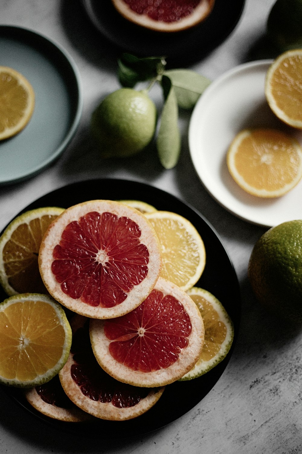 sliced orange fruit on black ceramic plate