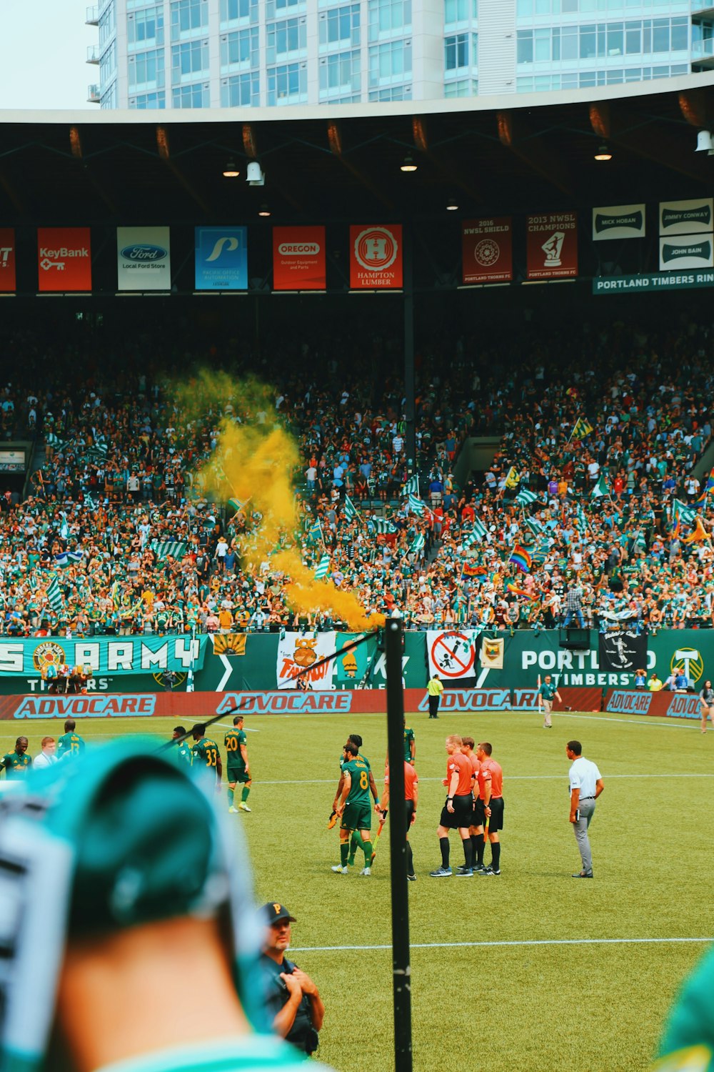 people playing soccer on stadium