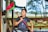 boy in gray crew neck t-shirt holding green and red stick