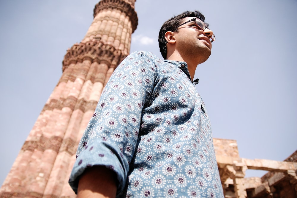 man in blue and red floral button up shirt wearing black sunglasses