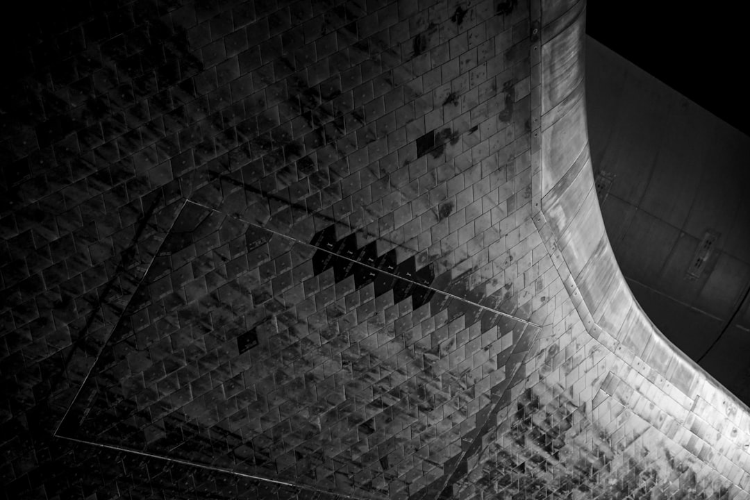 grayscale photo of brick wall, Tile detail on the bottom of Space Shuttle Atlantis from a recent trip to Kennedy Space C