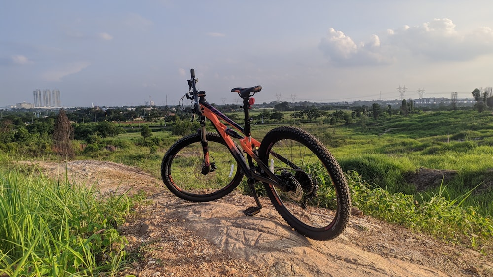 black and red mountain bike on brown dirt road during daytime