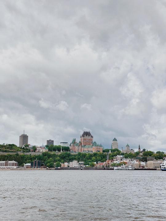 city buildings near body of water under cloudy sky during daytime in Traverse Québec-Lévis Canada