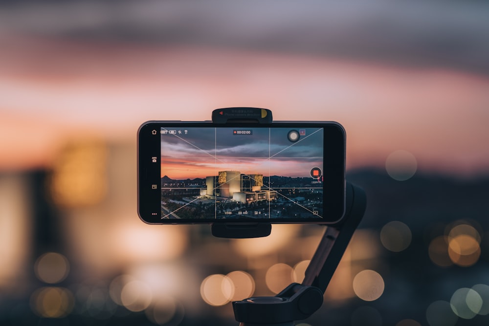 black samsung smartphone taking photo of city during sunset