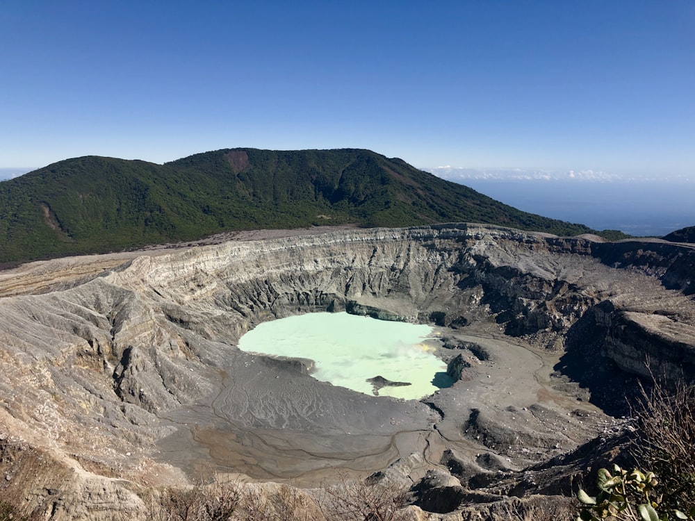 aerial view of lake in the middle of mountains during daytime