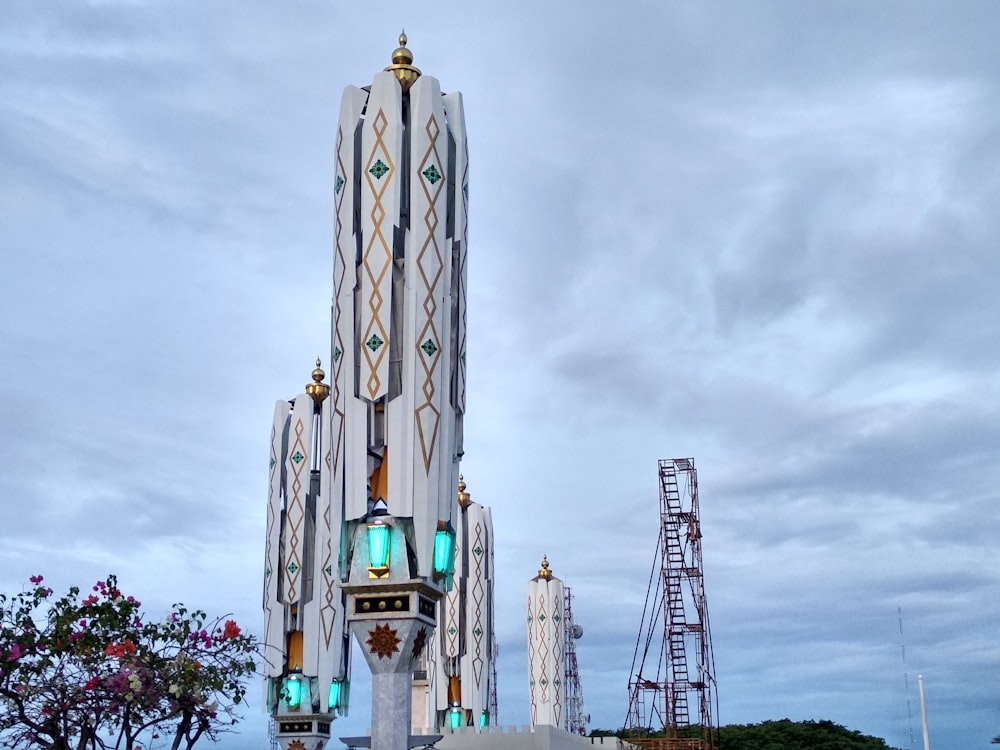 white and blue tower under cloudy sky