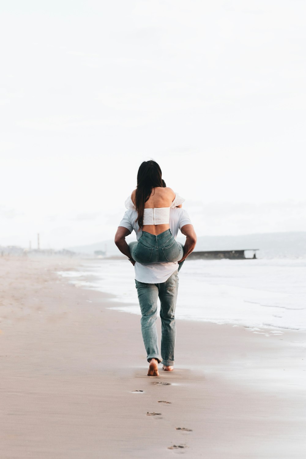 couple kissing on beach during daytime