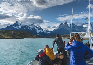 group of people sitting on boat on sea during daytime