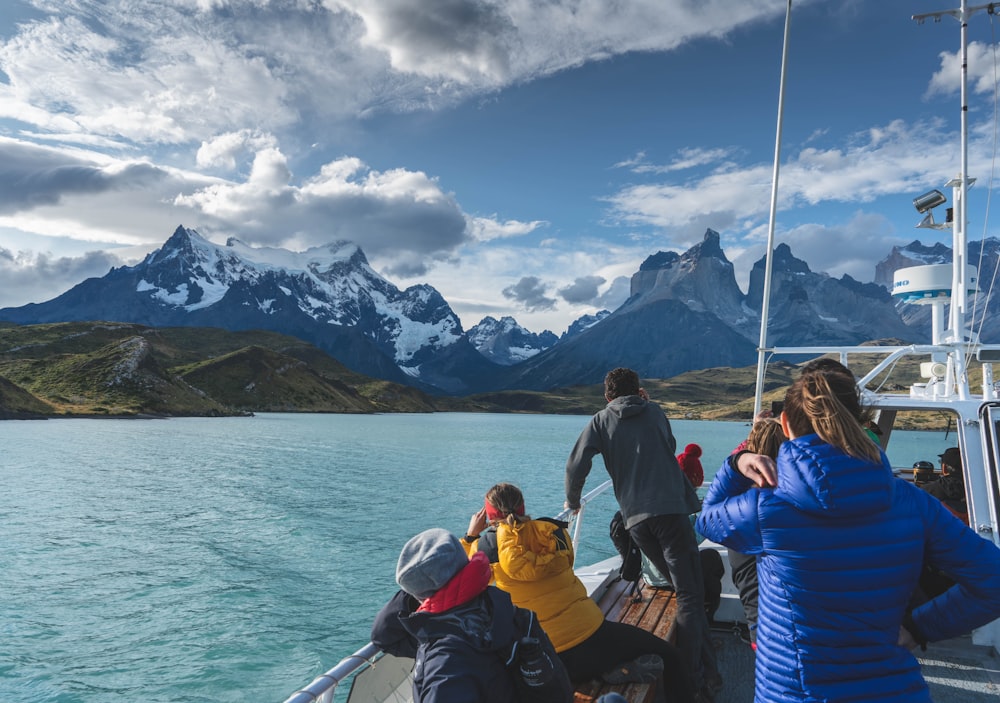 group of people sitting on boat on sea during daytime