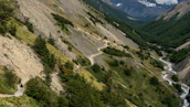 Hikers enjoying a scenic trail that winds through the lush green valleys surrounding Reschen Pass.