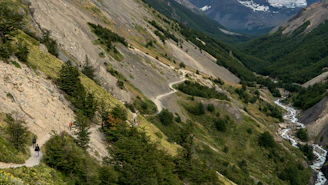 A scenic mountain valley in northern Pakistan with travelers enjoying a guided hike.