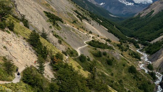 A scenic mountain valley in northern Pakistan with travelers enjoying a guided hike.