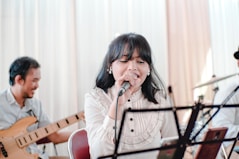 woman in white long sleeve shirt sitting on brown wooden chair