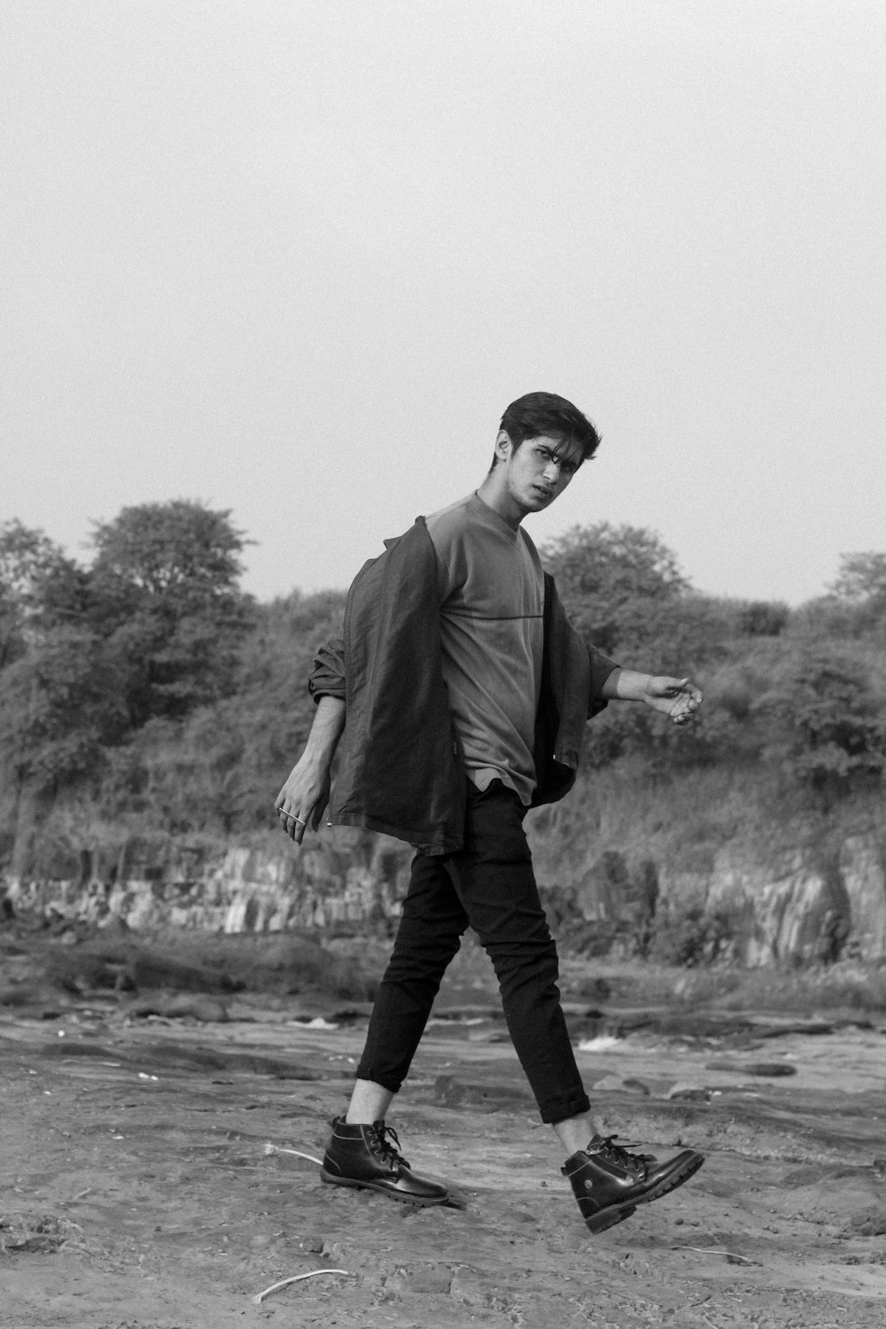 a black and white photo of a man walking