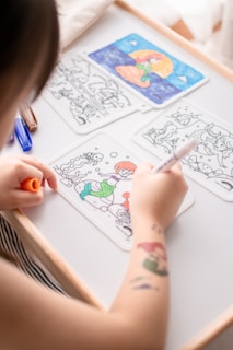 person drawing on white paper