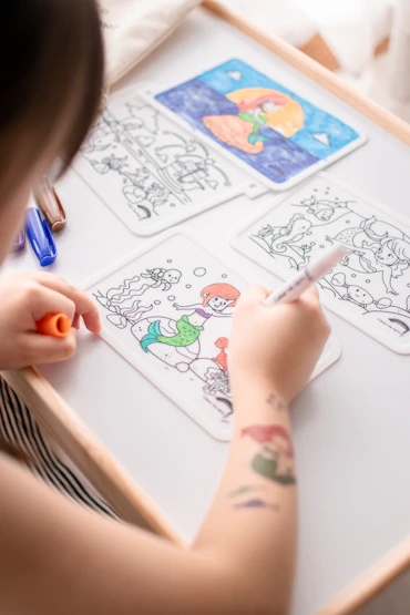 person drawing on white paper