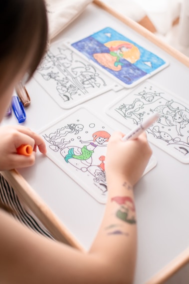 person drawing on white paper