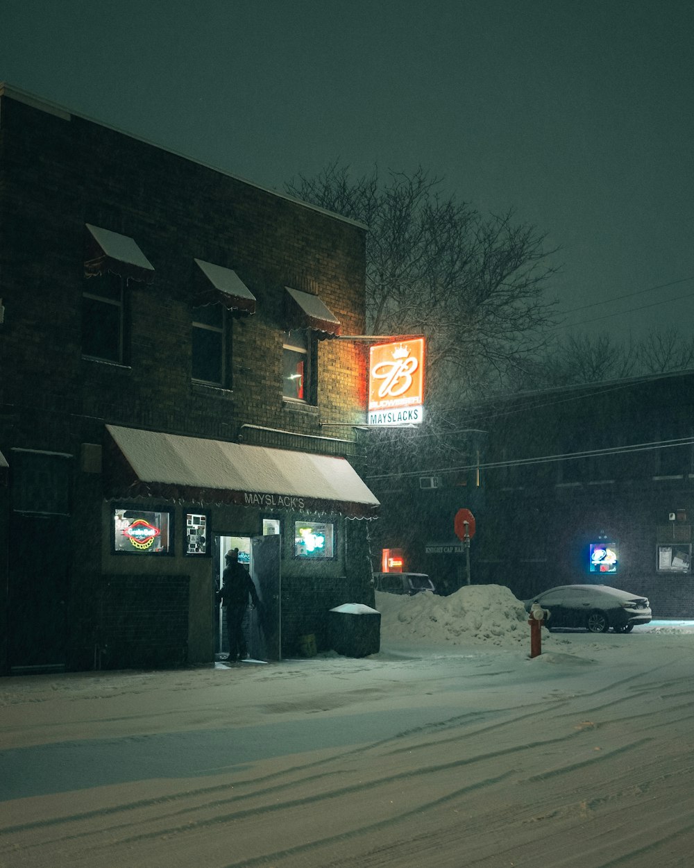 cars parked in front of store during night time