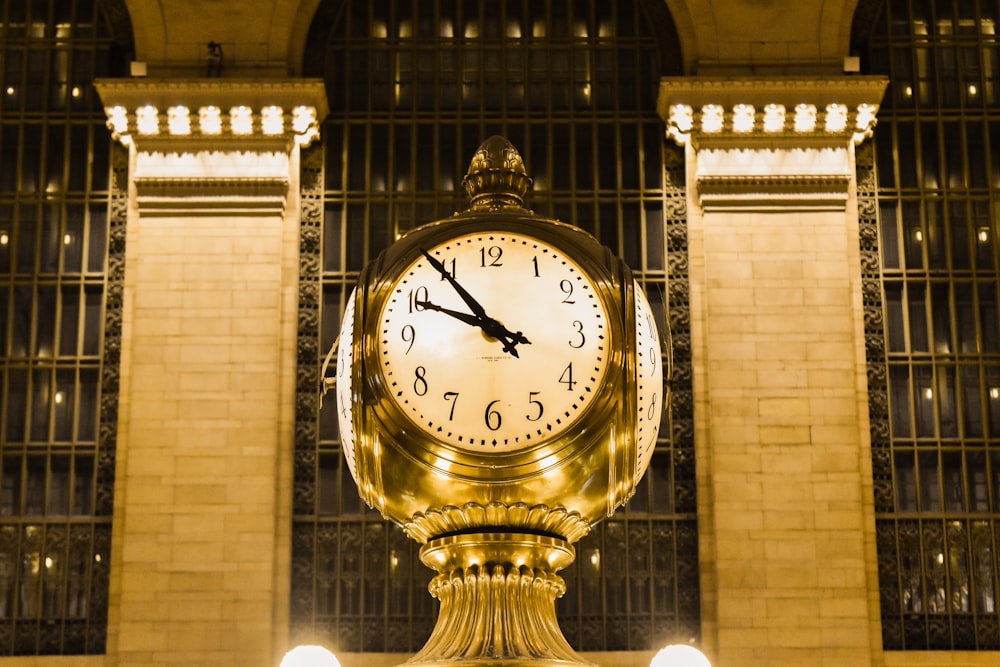 gold and white analog clock