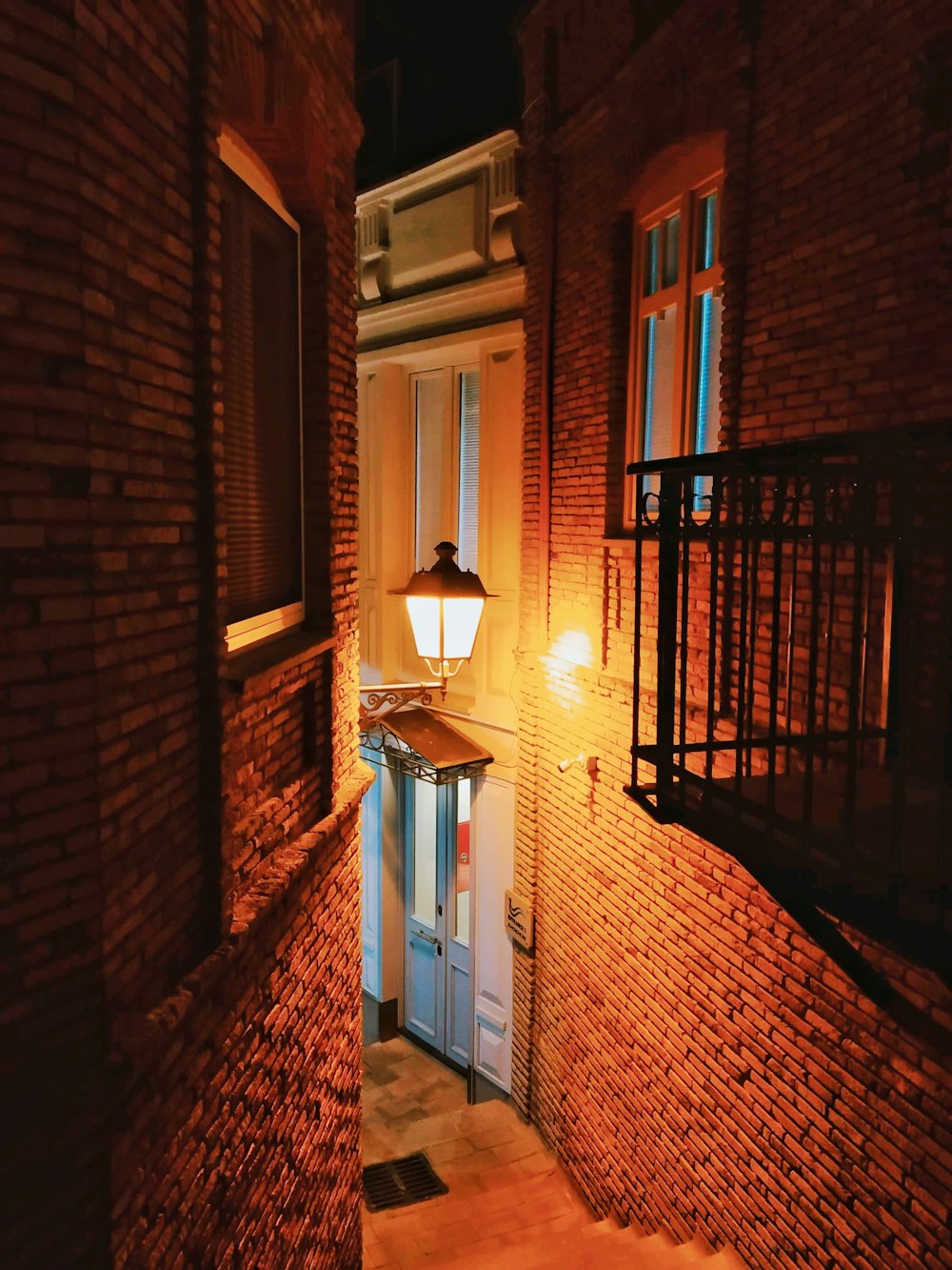 brown brick wall and white wooden door