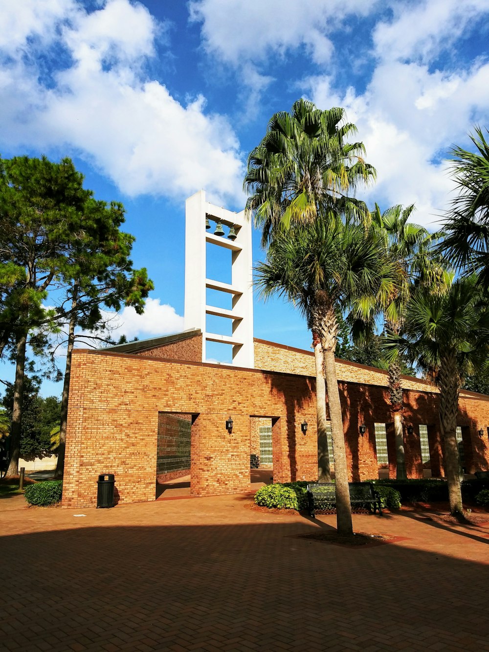 brown brick building near green trees during daytime