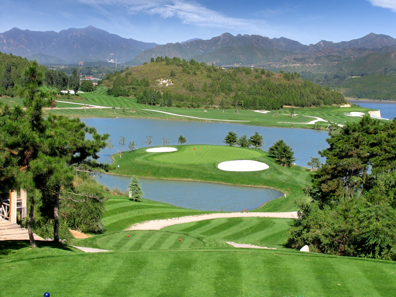 Parkland fairway beside a country house lake