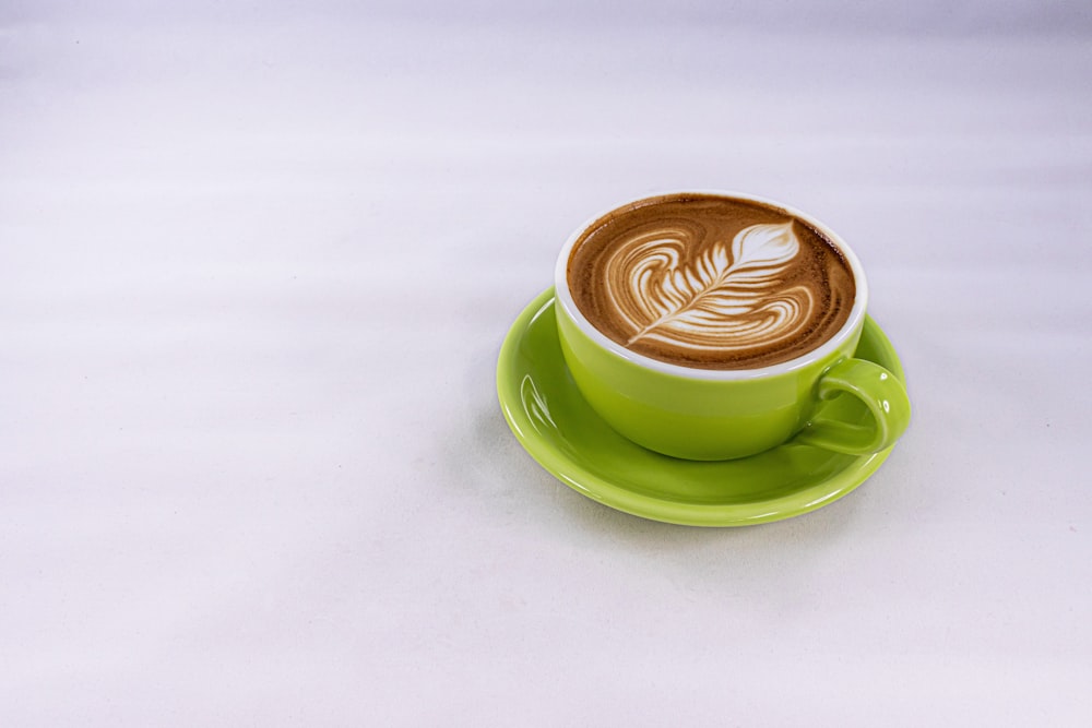 green ceramic cup with saucer