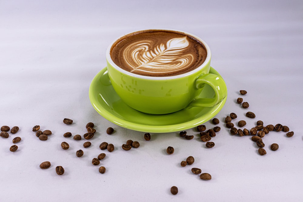 green ceramic cup with saucer