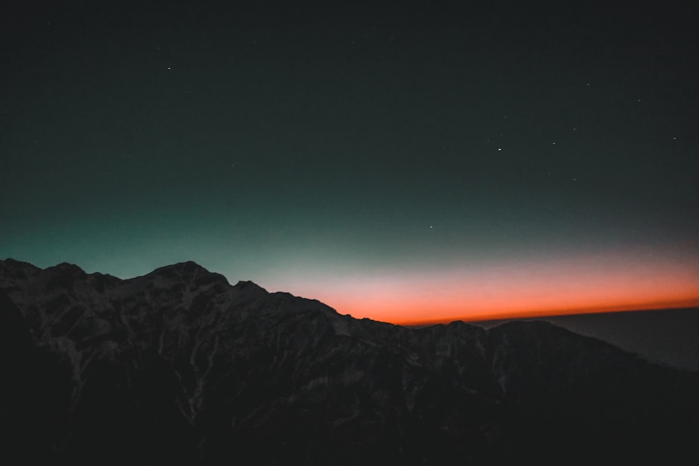 black and gray mountain under blue sky during night time