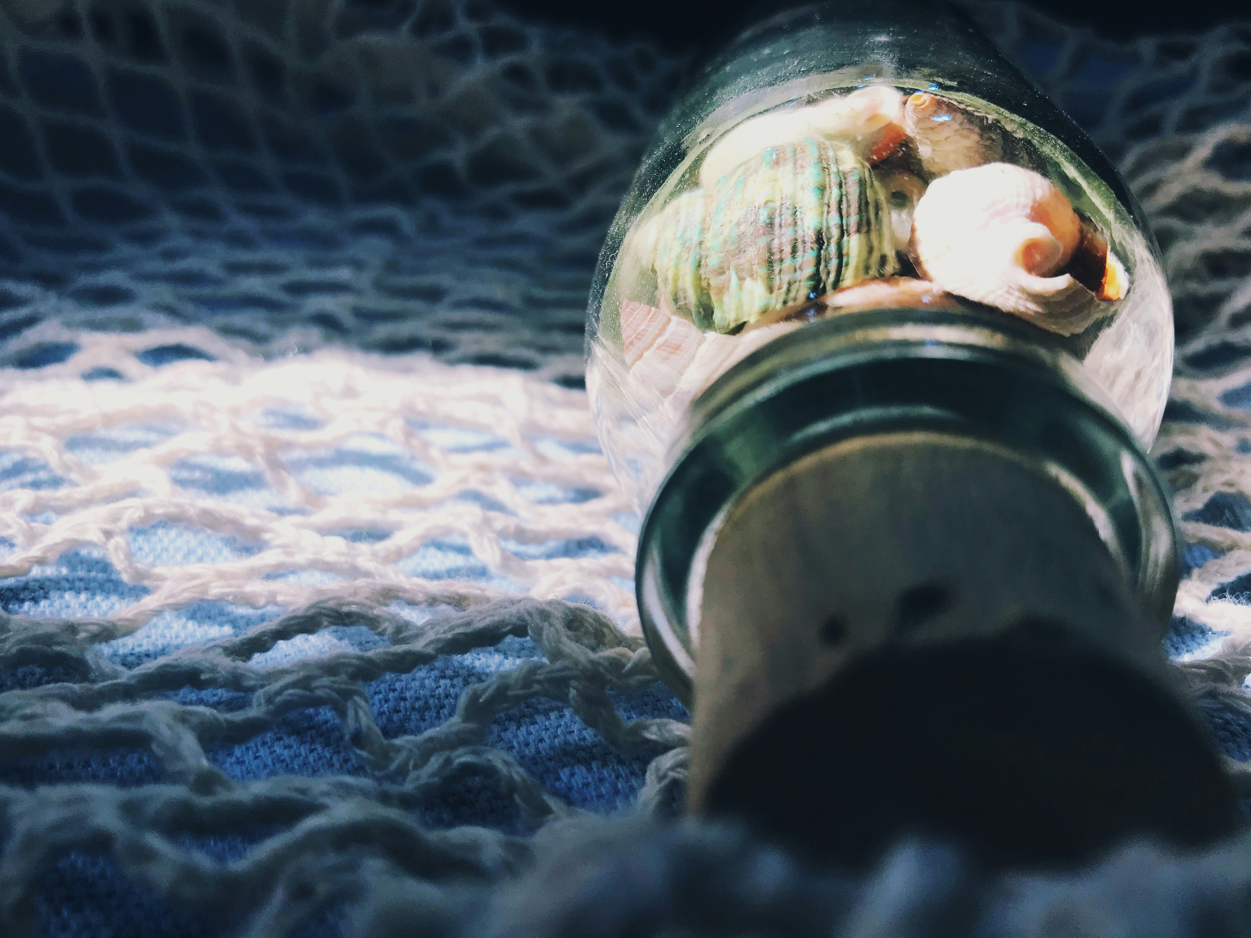 clear glass jar on blue textile