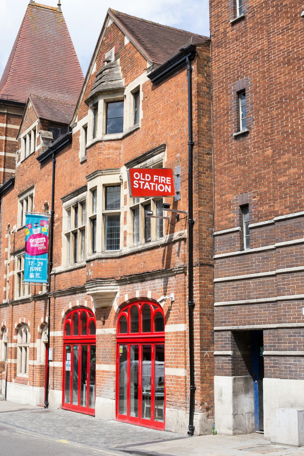 brown brick building with red wooden doors