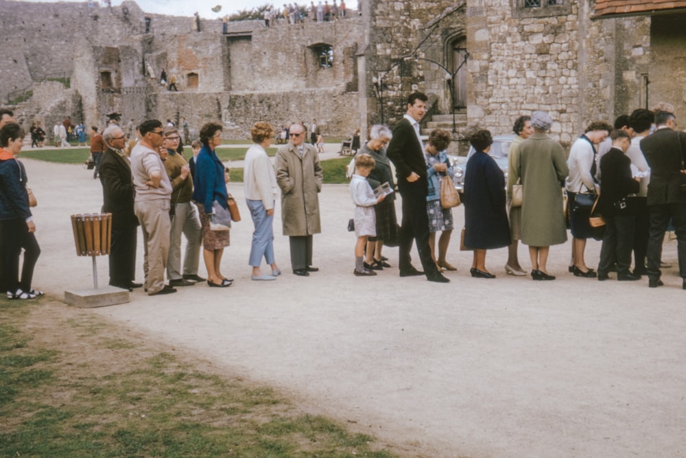 group of people standing on green grass field during daytime