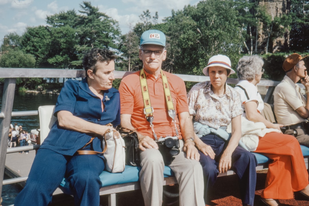 man in blue polo shirt sitting beside woman in white floral shirt