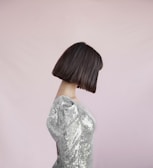 A client smiling with a sleek, shiny bob haircut.