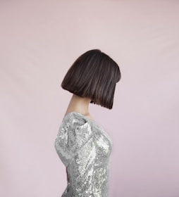 Back view of a sleek bob haircut with a shiny finish under warm salon lighting