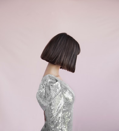 Sleek bob haircut with a glossy finish under soft lighting.
