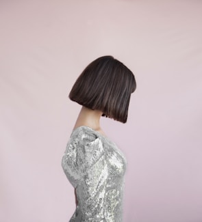 A sleek bob haircut styled with precision and shine on a smiling client.