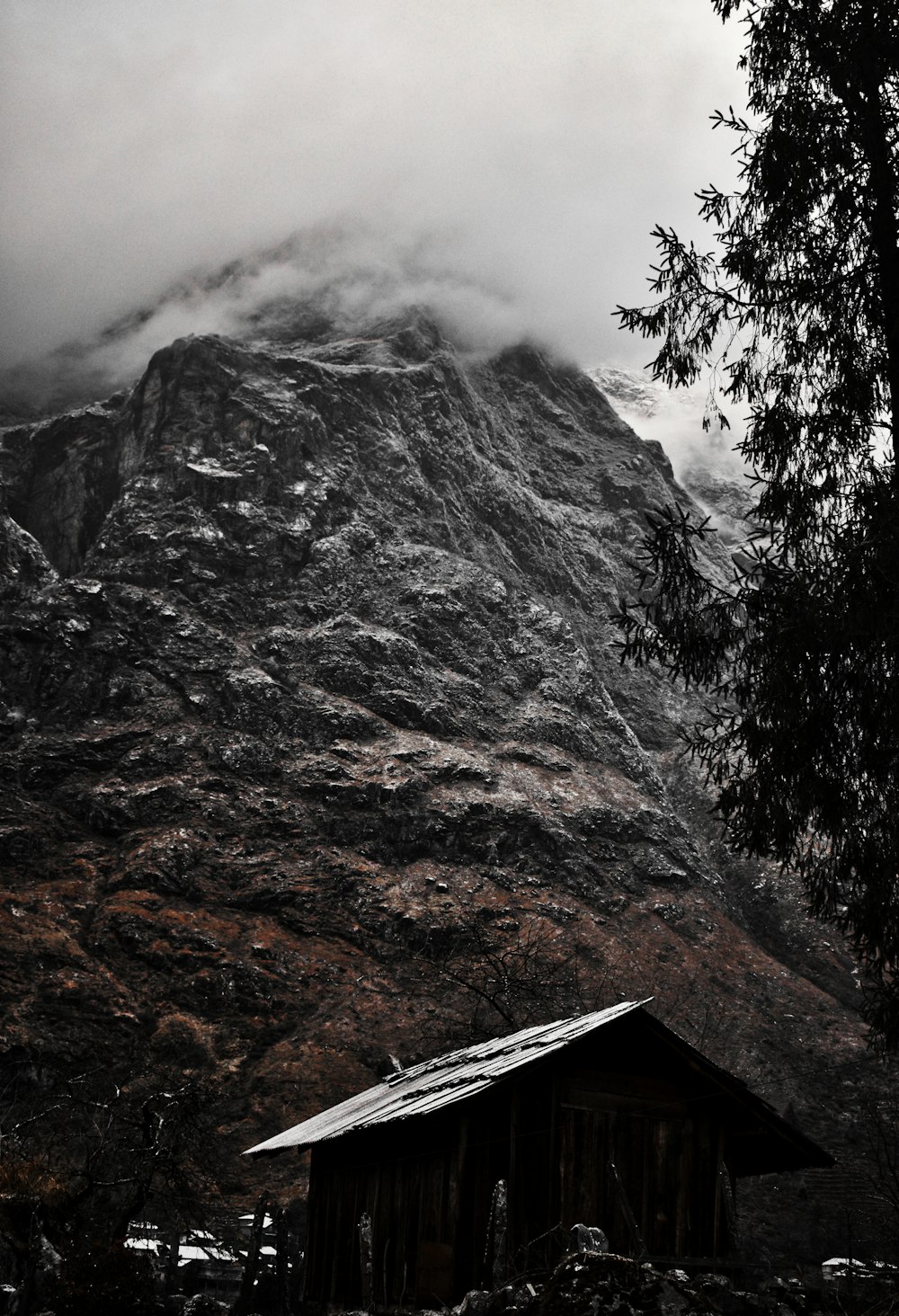 brown and gray mountain under white clouds during daytime