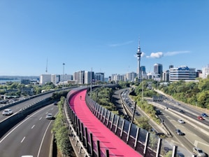 red metal fence near city buildings during daytime