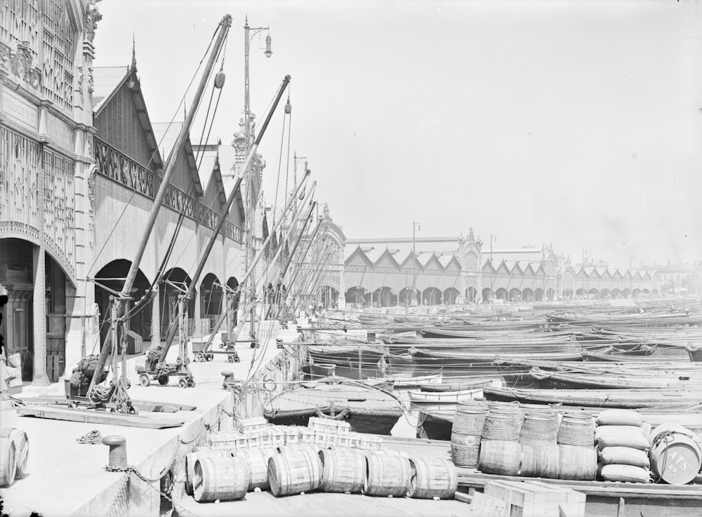 grayscale photo of sail boats on dock