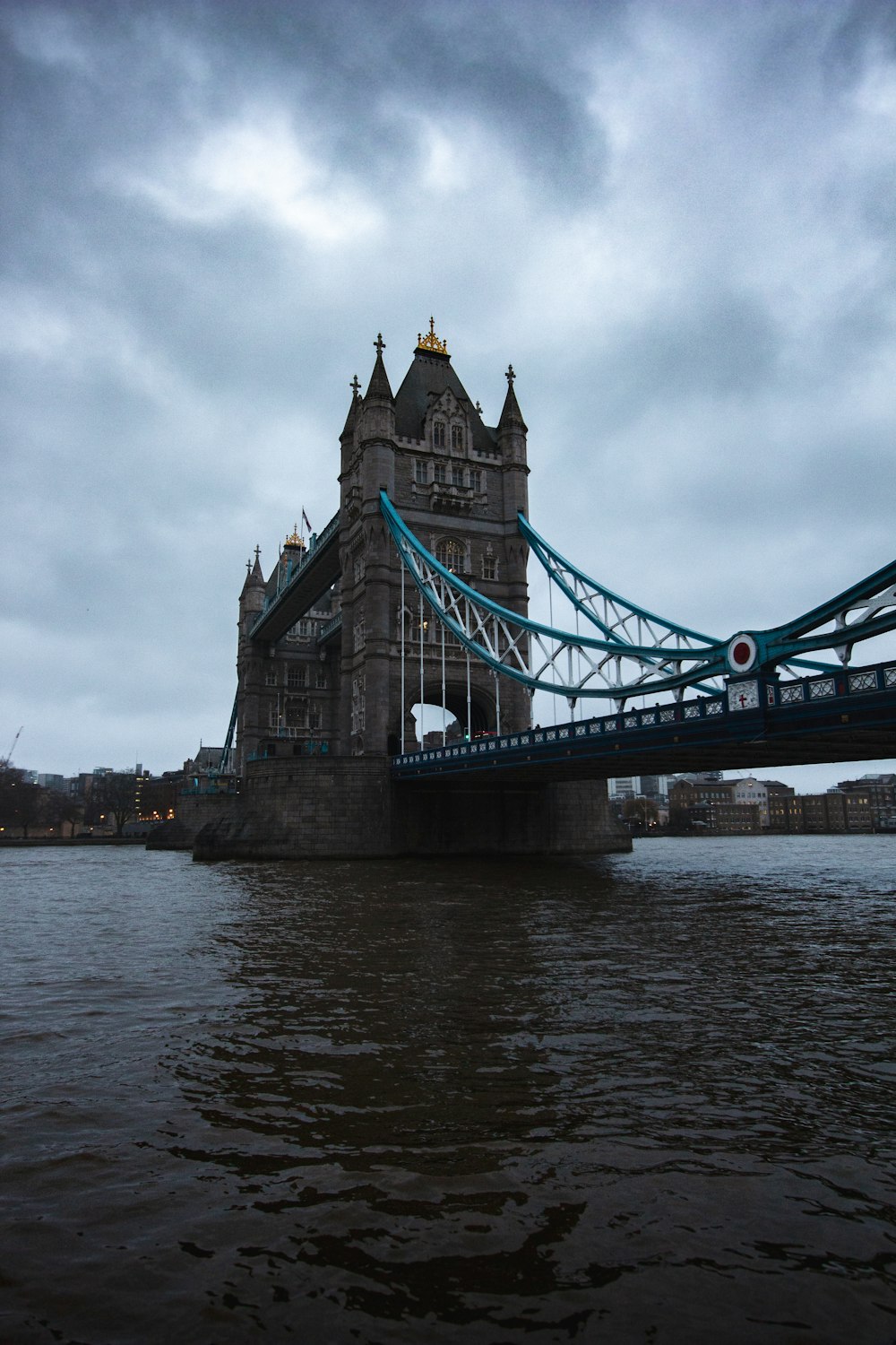 gray bridge under cloudy sky during daytime